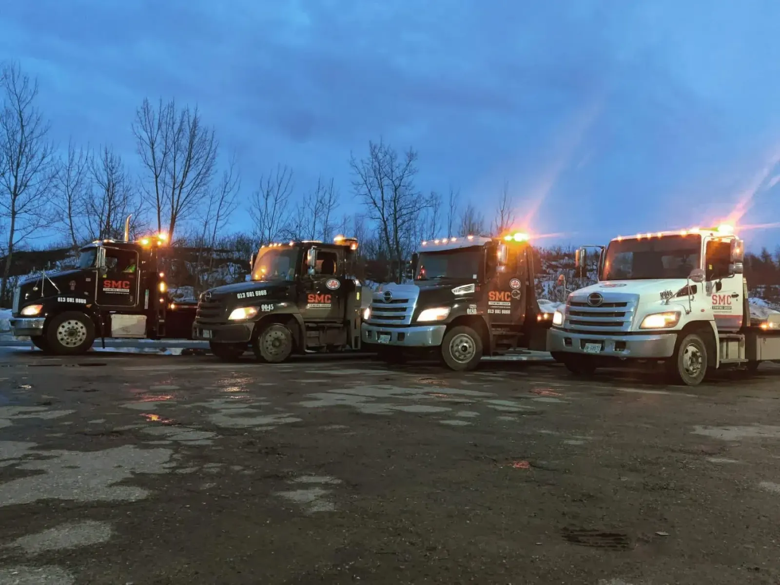 Canadian Towing fleet lined up at dusk in Ottawa