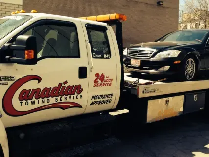 Flatbed tow truck providing tow truck service Ottawa for damaged vehicles