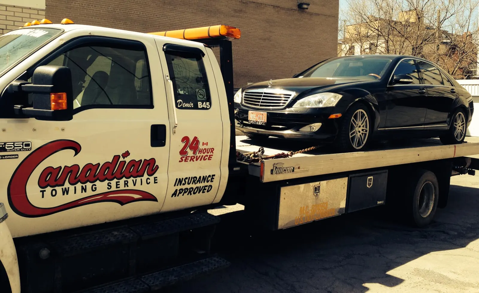 Canadian Towing flatbed loading a Mercedes
