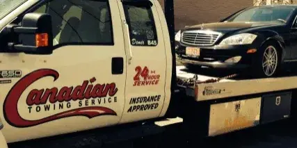 Canadian Towing flatbed truck loading a car in Ottawa for safe transport