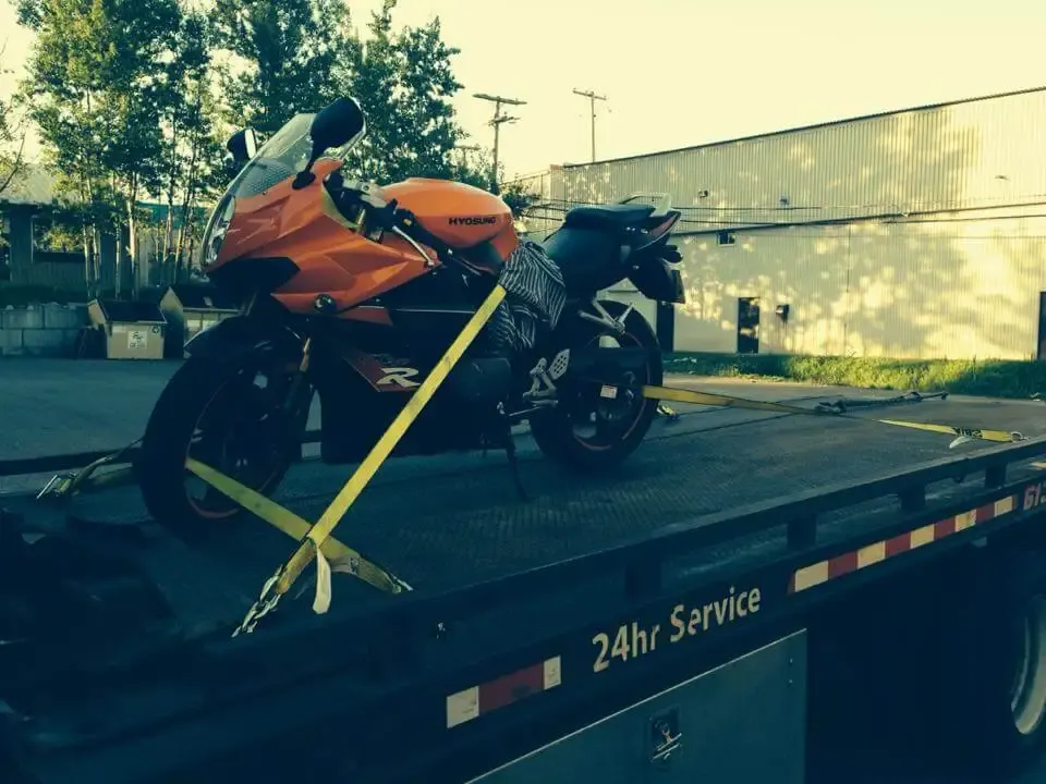 Motorcycle strapped on a Canadian Towing flatbed
